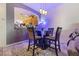 Cozy dining area with a glass-topped table, upholstered chairs, and modern pendant lighting at 7400 Quail Heights Ave, Las Vegas, NV 89131