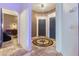 Elegant foyer with a decorative compass inlay in the tile floor and a view into other rooms at 7400 Quail Heights Ave, Las Vegas, NV 89131