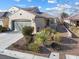 Charming single-story home featuring desert landscaping, a two-car garage, and a tile roof at 7400 Quail Heights Ave, Las Vegas, NV 89131