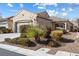 Inviting single-story home showcasing desert landscaping, a garage, and a beautiful tile roof at , Las Vegas, NV 89131