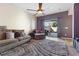 Comfortable living room featuring a ceiling fan and sliding glass doors to the backyard at 7400 Quail Heights Ave, Las Vegas, NV 89131