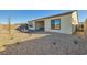 A home's backyard is landscaped with small rocks and a covered patio with outdoor seating at 10026 Honey Rose Ave, Las Vegas, NV 89143