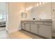 Stylish bathroom featuring a double vanity, tile floors, and serene ambiance, ensuring a relaxing experience at 10026 Honey Rose Ave, Las Vegas, NV 89143