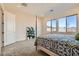 Inviting bedroom with carpet, large window and neutral tones, offering comfort and style at 10026 Honey Rose Ave, Las Vegas, NV 89143
