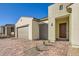 A modern style home featuring a brick driveway, three car garage, and landscaped front yard at 10026 Honey Rose Ave, Las Vegas, NV 89143