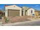 Attractive home featuring a two-car garage, well maintained xeriscaped front yard, and stylish accents at 10026 Honey Rose Ave, Las Vegas, NV 89143