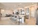 Spacious open-concept kitchen with island bar and stainless steel appliances, flowing into dining area at 10026 Honey Rose Ave, Las Vegas, NV 89143