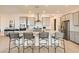 Contemporary kitchen with large island, stainless steel appliances, and elegant gray cabinetry at 10026 Honey Rose Ave, Las Vegas, NV 89143