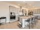 Stylish kitchen with marble backsplash, stainless steel hood, and a spacious center island with bar seating at 10026 Honey Rose Ave, Las Vegas, NV 89143