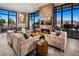 Lounge area featuring comfortable seating, modern fireplace, and scenic views at 10026 Honey Rose Ave, Las Vegas, NV 89143
