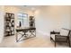 Well-lit home office with large window, modern furnishings, and a comfortable seating area at 10026 Honey Rose Ave, Las Vegas, NV 89143
