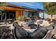 Inviting outdoor patio with comfortable seating and dining areas with desert landscaping, perfect for entertaining at 10026 Honey Rose Ave, Las Vegas, NV 89143