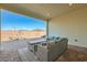 Covered patio featuring outdoor seating and a brick-paved floor, perfect for relaxing and entertaining at 10026 Honey Rose Ave, Las Vegas, NV 89143