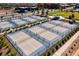 Aerial view of multiple tennis courts, surrounded by landscaping in a community setting at 10026 Honey Rose Ave, Las Vegas, NV 89143