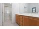 Bathroom showcasing a dual sink vanity, a shower with glass door and ample counter space at 10300 Pinto Creek Ln, Las Vegas, NV 89144