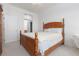 Bright bedroom with a wood bed frame and a view of the bathroom and closet at 10300 Pinto Creek Ln, Las Vegas, NV 89144