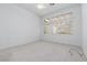 Light and airy bedroom with large window and neutral carpet at 10300 Pinto Creek Ln, Las Vegas, NV 89144