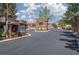 Community entrance with a stone gatehouse and signage for a secure and welcoming entry at 10300 Pinto Creek Ln, Las Vegas, NV 89144
