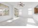 Spacious living room with ceiling fan, windows, and sliding glass door allows natural light to fill the space at 10300 Pinto Creek Ln, Las Vegas, NV 89144