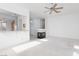 Living area with a fireplace, ceiling fan, and open layout create a comfortable atmosphere at 10300 Pinto Creek Ln, Las Vegas, NV 89144
