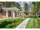 Community park area featuring lush green grass, walking path, seating, and shaded structures for outdoor enjoyment at 10300 Pinto Creek Ln, Las Vegas, NV 89144