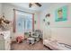 Cozy Bedroom featuring a crib, rocking chair, and adorable decorations creating a warm and inviting atmosphere at 10393 Rose Palisade St, Las Vegas, NV 89141
