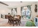 Bright dining area features a table for six and sliding doors to a balcony at 10393 Rose Palisade St, Las Vegas, NV 89141