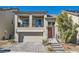 Charming two-story home with a balcony, brick driveway, and a well-manicured front yard at 10393 Rose Palisade St, Las Vegas, NV 89141