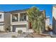 Inviting two-story home featuring a balcony, stone steps to the front door, and desert landscaping at 10393 Rose Palisade St, Las Vegas, NV 89141