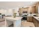 Well-lit kitchen with a center island, stainless steel appliances, and neutral-toned cabinetry at 10393 Rose Palisade St, Las Vegas, NV 89141