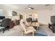 Relaxing living room featuring neutral carpet, ceiling fan and comfortable seating arrangement at 10393 Rose Palisade St, Las Vegas, NV 89141