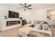 Stylish living room with a fireplace, large sectional sofa, and modern decor at 10393 Rose Palisade St, Las Vegas, NV 89141
