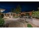 Night view of backyard with patio featuring a cozy fire pit, outdoor kitchen, and landscaped garden at 10507 Bryn Haven Ave, Las Vegas, NV 89135