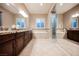 Bathroom featuring dual sinks, granite countertops, soaking tub, and tiled floors at 10507 Bryn Haven Ave, Las Vegas, NV 89135