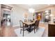 Elegant dining room featuring a modern chandelier, hardwood floors, and seating for six at 10507 Bryn Haven Ave, Las Vegas, NV 89135