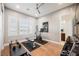 Bright home gym with hardwood floors, natural light, and space for various workout equipment at 10507 Bryn Haven Ave, Las Vegas, NV 89135