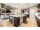 Bright, open kitchen with a granite island, stainless appliances, and hardwood flooring at 10507 Bryn Haven Ave, Las Vegas, NV 89135