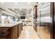 Open kitchen with stainless steel appliances and a seamless view of the living room at 10507 Bryn Haven Ave, Las Vegas, NV 89135
