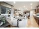 Open-concept kitchen featuring a dining table, island, and stainless steel appliances at 10507 Bryn Haven Ave, Las Vegas, NV 89135