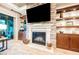 Close-up of the living room fireplace with a stone surround, built-in shelves, cabinets, and wood flooring at 10507 Bryn Haven Ave, Las Vegas, NV 89135