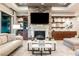 Cozy living room with modern fireplace, built-in cabinets, shelves, and a comfortable seating area at 10507 Bryn Haven Ave, Las Vegas, NV 89135
