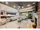 Spacious living room features a stone fireplace, hardwood floors, and sliding glass doors to the backyard at 10507 Bryn Haven Ave, Las Vegas, NV 89135