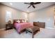 Comfortable main bedroom featuring neutral carpet, dark wood furniture, and a ceiling fan at 10507 Bryn Haven Ave, Las Vegas, NV 89135