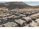 Extensive aerial view of a densely populated neighborhood with homes and green spaces nestled against a mountain backdrop at 10507 Bryn Haven Ave, Las Vegas, NV 89135