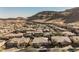 Wide aerial shot of a residential neighborhood set against a backdrop of rolling hills, offering a serene living environment at 10507 Bryn Haven Ave, Las Vegas, NV 89135