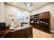 Beautiful home office with custom built-in shelving, hardwood floors, and large desk with lots of light at 10507 Bryn Haven Ave, Las Vegas, NV 89135