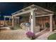 A well-appointed outdoor kitchen features a built-in grill and a charming pergola in a beautifully landscaped backyard at 10507 Bryn Haven Ave, Las Vegas, NV 89135