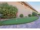 Backyard putting green adjacent to the house with manicured landscaping, and stone pavers at 10507 Bryn Haven Ave, Las Vegas, NV 89135