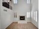 Bright living room featuring a cozy fireplace and multiple windows with plantation shutters at 10530 Eagle Nest St, Las Vegas, NV 89141