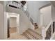 Staircase with black metal railing, tile landing and view of the bedroom entrance at 10530 Eagle Nest St, Las Vegas, NV 89141